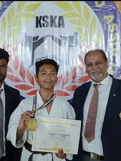 Another proud moment with Naresh and officials after his gold medal win, highlighting the recognition he earned at the state level.
