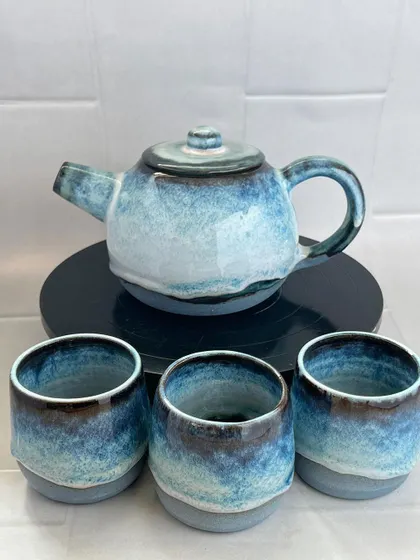 There is something so comforting about a handmade tea set. This wheel-thrown stoneware teapot and matching cups feature a beautiful blue glaze that reminds me of a calm sea. It is perfect for sharing a quiet moment.