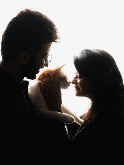A dramatic silhouette of my friends with their cat. We created this gorgeous, high-contrast image right in their home, proving you don’t need a studio to make fine art portraits.