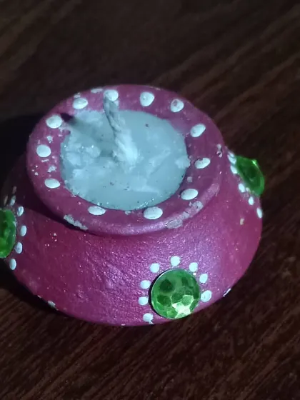 This is one of my handmade decorative diyas, perfect for celebrating an eco-friendly Diwali. Each one is crafted from clay and decorated by hand to support local, traditional artistry.