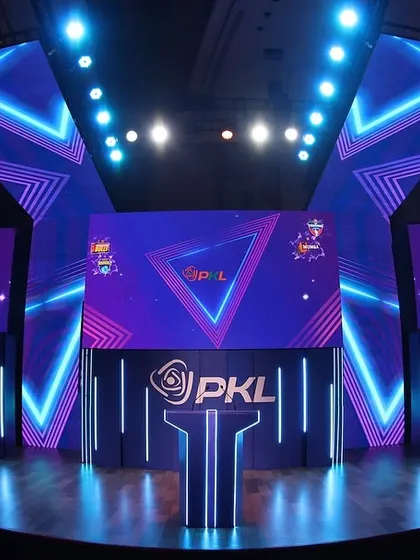 A full view of the impressive stage we designed and built for the PKL Player Auction. The geometric neon lighting and multiple LED screens create a modern and professional environment fit for a premier sports league.