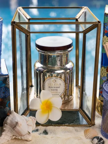 Our Blue Island Water candle, housed in a beautiful mercury glass jar. Placed in a lantern by the pool, it creates a fresh and aquatic ambiance, perfect for beating the summer heat.