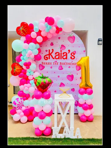 Kaia's "Berry 1st Birthday" was a sweet and unique strawberry theme. The decor features a pink and red color palette, strawberry-shaped balloons, and a backdrop with a cute strawberry print.