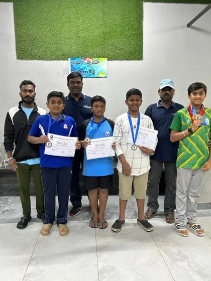 A group of our junior swimmers with their coaches, celebrating their collective success and medal wins at the interschool competition.