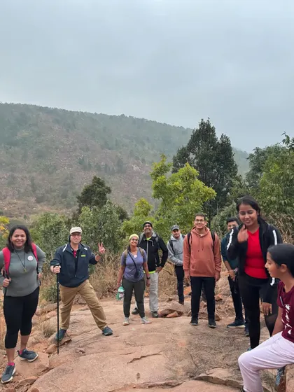 Trekkers navigating a rocky path, with one giving a thumbs-up. Our trails offer a mix of easy paths and fun challenges.