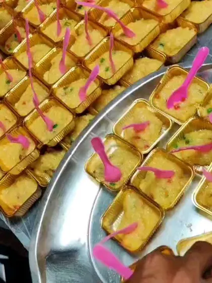 Our fruit custard dessert being served in individual foil cups. The bright pink spoons add a fun touch of color to the dessert table.