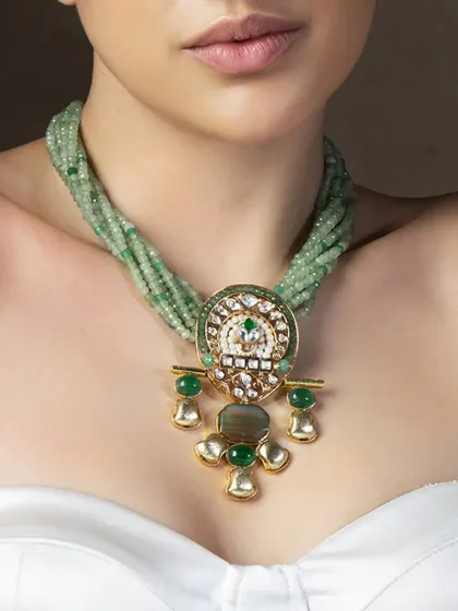 A closer view of the unique pendant necklace, highlighting the combination of polki, enamel, and semi-precious stones.