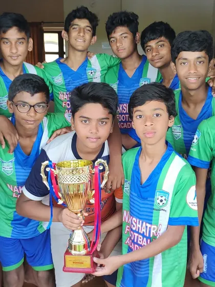 The U-15 team proudly holding the winner's trophy after a successful All India tournament in Goa. These moments are what we strive for.