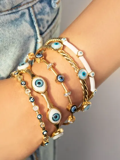 My evil eye bangles are perfect for your go-to stack. This image shows a variety of my evil eye designs, from classic to colorful.