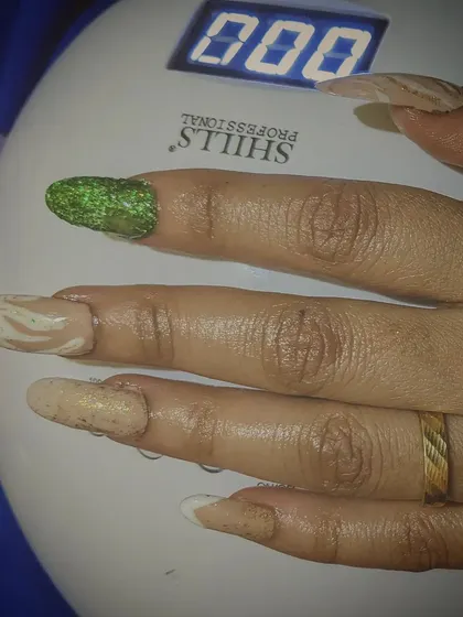 The final set curing under my professional UV lamp. This step ensures the gel polish and extensions are rock-solid and will last for weeks without chipping, locking in the intricate designs.