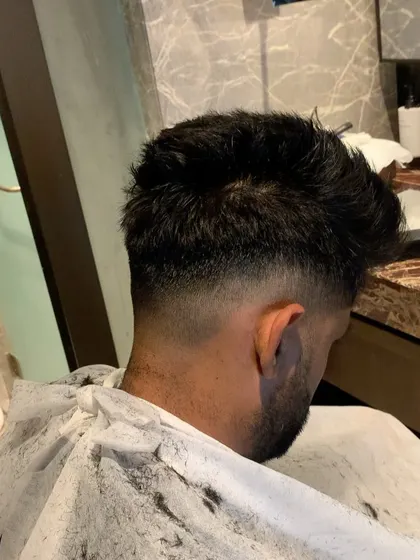 Here's a look at the taper fade I gave Suryakumar Yadav. It's a classic, clean style that looks great from every angle.