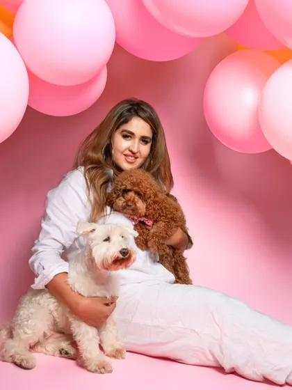 A beautiful family portrait from a birthday shoot, with the owner holding her two adorable dogs against a vibrant pink backdrop. I always encourage hoomans to jump in for a few shots.