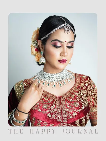 A close-up bridal or traditional portrait focusing on the intricate makeup and jewelry. The soft lighting and gentle pose highlight the elegance and grace of the subject, perfect for a beauty or bridal portfolio.