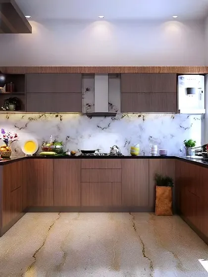 A classic U-shaped kitchen with warm wood cabinets and a white marble backsplash. Pendant lights over the peninsula and ample under-cabinet lighting ensure a well-lit workspace.