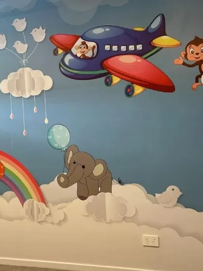 This whimsical sky-themed wallpaper is perfect for a nursery or playroom. It features cute animals like monkeys and elephants floating on clouds and in airplanes, creating a sweet and imaginative dreamscape for little ones.