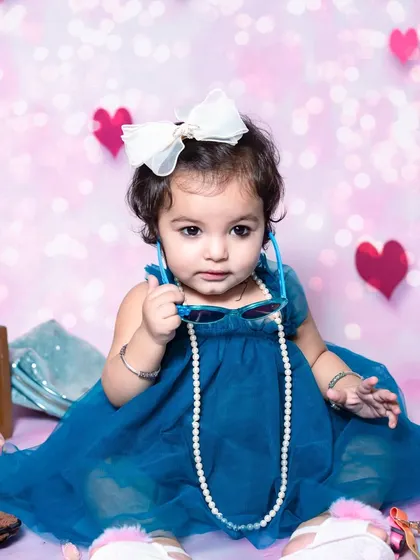 A curious look from this little one during her fun dress-up photoshoot in the studio.