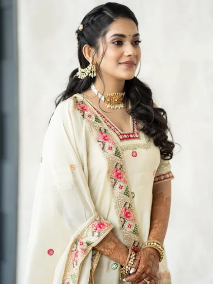 A close up showing the details of her embroidered outfit and the soft makeup.