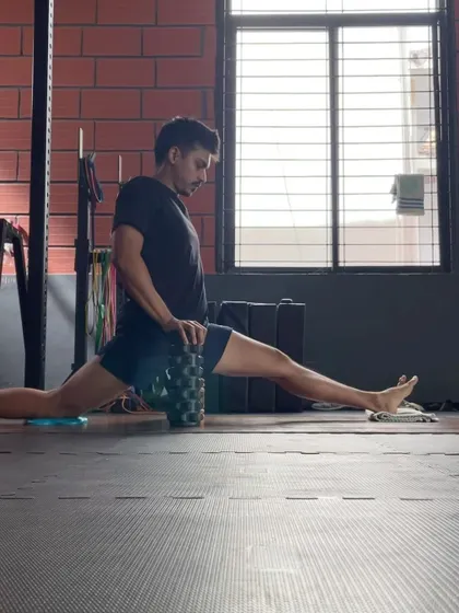 A snapshot of my front splits progress, using a foam roller for support. This tool helps me maintain tension and control as I work on increasing my hip flexibility.