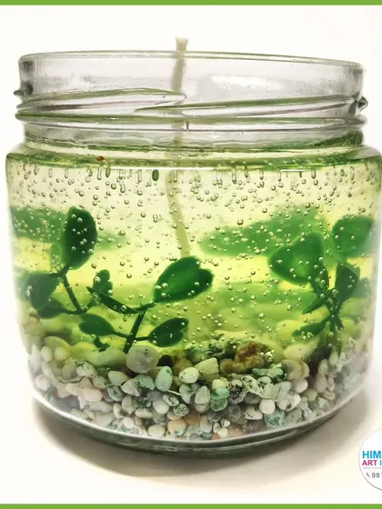 A beautiful gel candle creating an underwater scene with pebbles and faux plants. Learn to create miniature worlds inside your candles.