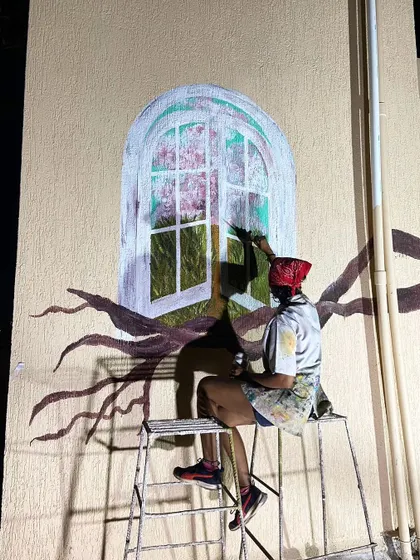 Sitting on a ladder to reach the top of the arched window mural. Night sessions are often the most peaceful.