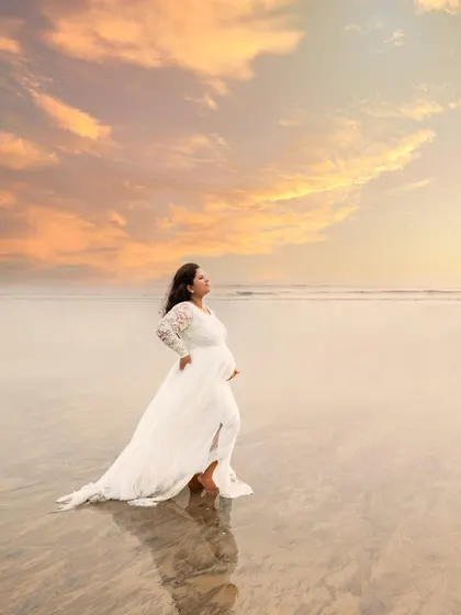 There is a unique power in a mother standing strong, waiting to meet her baby. This outdoor portrait, taken during the golden hour at a Mumbai beach, captures that serene and powerful solitude against a breathtaking sunset.