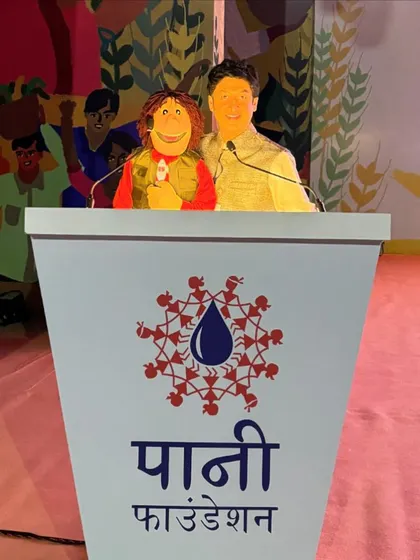 At the Paani Foundation event, standing at the podium with my puppet. We had the opportunity to address the 7000 farmers in attendance.