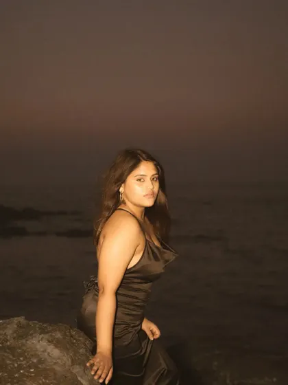 A similar night portrait from the beach session, capturing a different pose. The simplicity of the composition puts all the focus on the subject's connection with the camera.