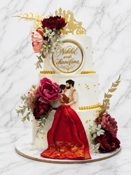 This two-tier wedding cake is one of my proudest creations. It features delicate floral arrangements, a personalized couple's emblem, and a stunning 3D fabric effect on the bride's traditional red dress.