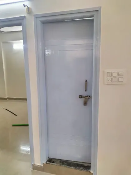 A freshly painted door and frame in a light blue-grey. This solid colour finish is applied evenly for a smooth, professional result that is easy to clean.