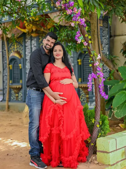 A sweet couple's portrait by a beautiful purple door. The climbing flowers add a touch of natural beauty to this outdoor shot.