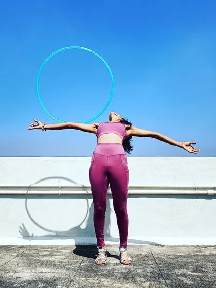 A joyful pose celebrating balance and openness. Using the hoop as a frame helps to visualize the space I'm creating in my body.