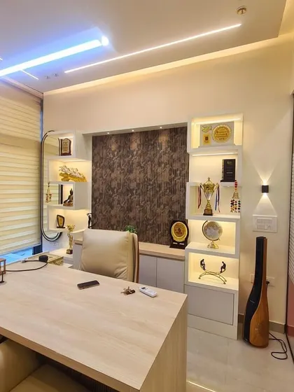 This is my personal cabin in the new office, where I meet clients. The desk is placed according to Vastu for stability, and the shelves display awards and trophies, which adds to the positive and motivating energy of the space.