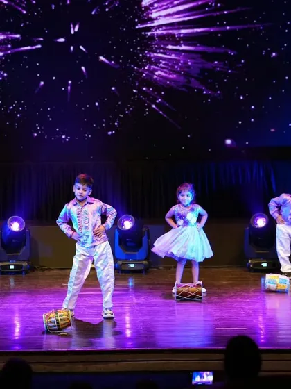 Our little performers using drums as props in their adorable Bollywood number, adding a unique rhythmic element to their dance.