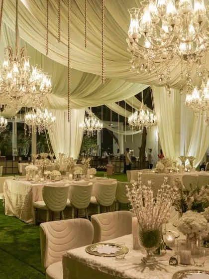 We created a dreamscape of ivory and gold for this luxurious reception. The space was filled with flowing drapery, dozens of crystal chandeliers, and all-white floral arrangements, crafting an atmosphere of pure elegance and romance.