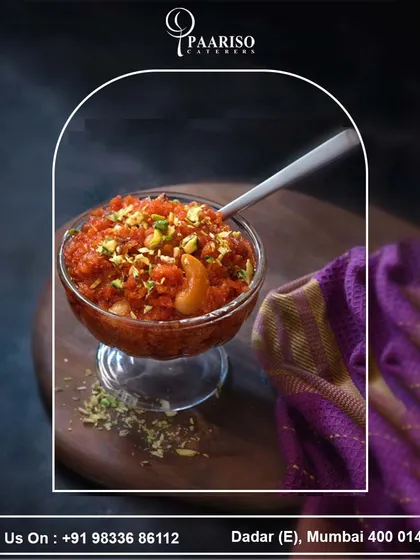 Another view of our rich Gajar Ka Halwa, served in a glass bowl and generously topped with chopped pistachios and cashews. It's a comforting dessert that warms the soul.