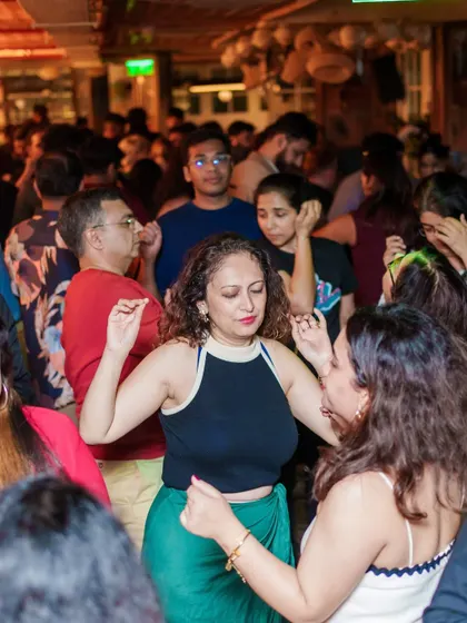 A packed dance floor with everyone moving to the beat. This is the collective energy that makes VIBE CHECK special.