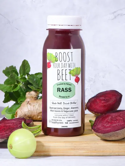 This image for a beetroot juice uses a similar ingredient focused setup. The rich, earthy tones of the beet and ginger against a clean background make the product look both healthy and appealing.