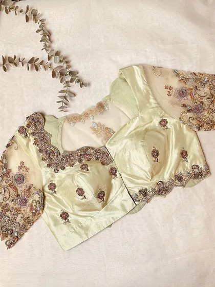 The front view, with delicate floral buttas and heavily embroidered sheer sleeves.