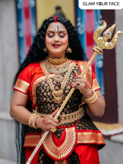 A full view of the Durga Puja look. The combination of traditional attire, heavy jewelry, and divine makeup with the third eye detail creates a truly memorable and emotional image.