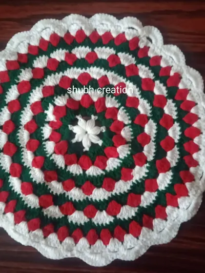 This circular mat features a festive color scheme of red, green, and white in a repeating petal pattern.