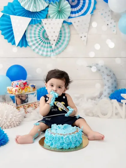 A sweet moment of discovery as this little one tastes his birthday cake for the first time during his pre-birthday photoshoot.