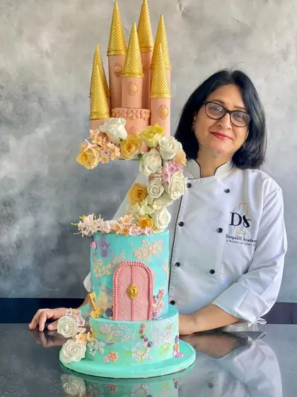 Me with my floating castle cake project. This was a week of intensive learning that pushed my skills to a new level.