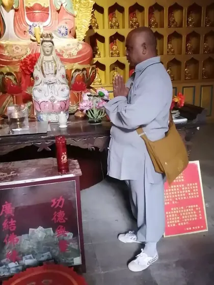 Offering prayers inside a hall at the Songshan Shaolin Temple. Devotion and spirituality are intertwined with the physical practice of Kung Fu.