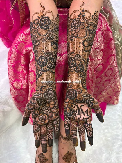 Another view of the 'YM' mehendi, showing the intricate rose patterns and detailed fillers that cover the hands and arms.