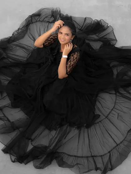 A similar artistic shot of the black tulle gown, this time in black and white, highlighting the delicate ruffles and layers.
