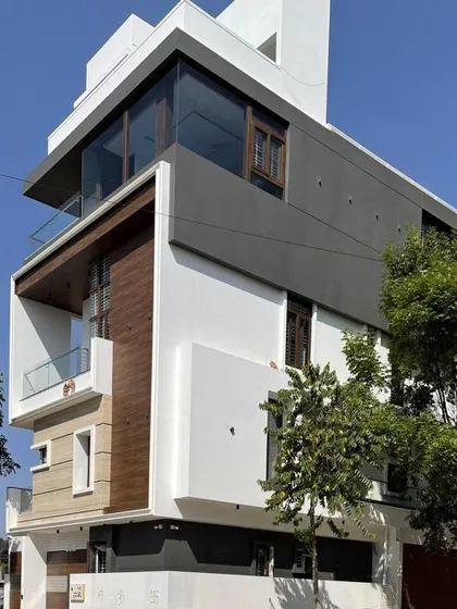 This angle showcases the building's massing, with gray and white volumes stacked to create a dynamic composition that changes with the light.