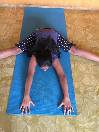 The same student, demonstrating consistent form in Upavistha Konasana.