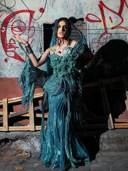 An artistic shot showcasing the dramatic, flowing silhouette of the Vaishali S. couture gown on Sushant Divgikr. The makeup adds to the ethereal and mysterious vibe.