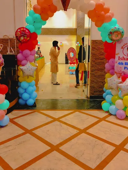 This is the entrance I created for the 'Candyland' party. A colorful balloon archway and themed cutouts like an ice cream cone welcome guests into the event space.