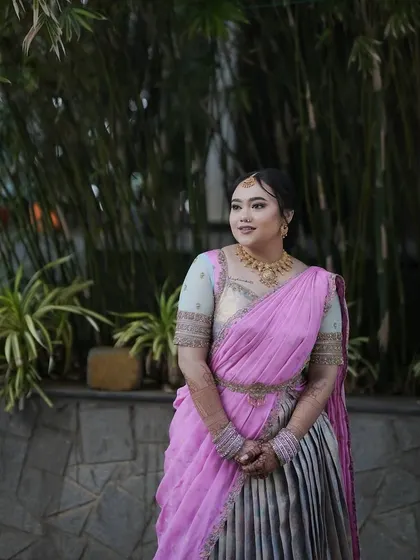 A portrait of the client, capturing her joy and the beauty of the traditional outfit.